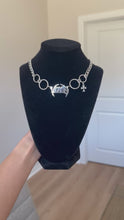 Load and play video in Gallery viewer, V RING CROSS CHOKER

